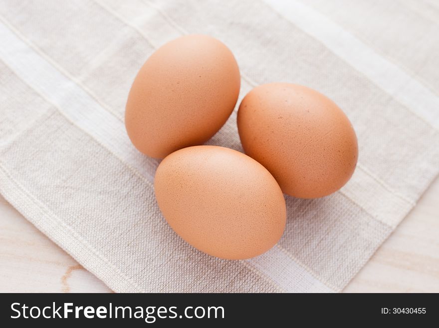 Three eggs isolated on fabric background