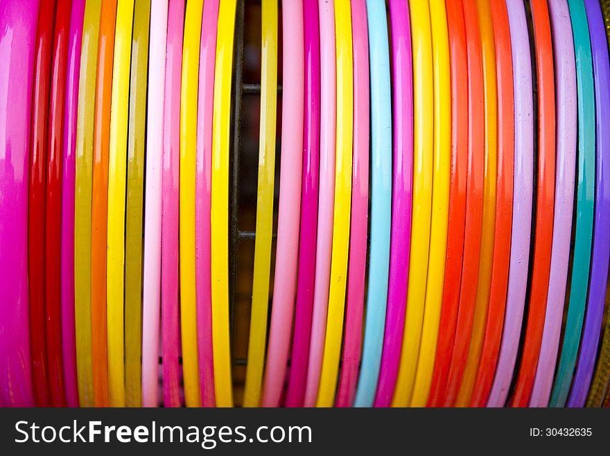 Colorful plastic bangle hanging in the row