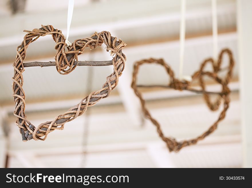 Wooden Weaved Hearts Hanging Off Roof Trusses At Wedding, Select