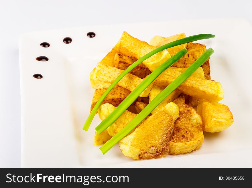 Slide fried potatoes with shoots of green onions