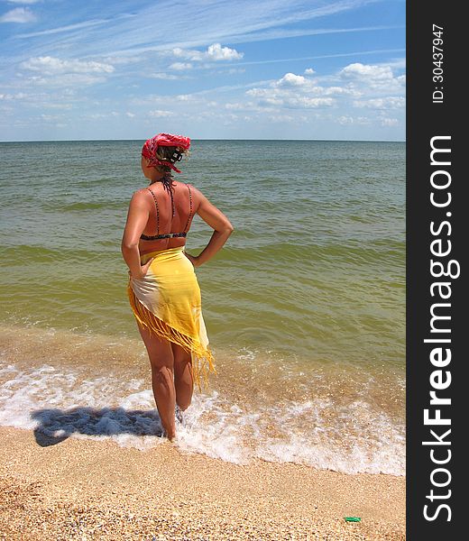 Girl in bathing suit standing at the seacoast. Girl in bathing suit standing at the seacoast