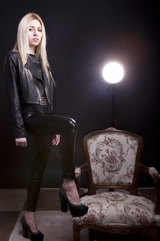 Sensual Blonde With A Leg On A Vintage Chair And A Studio Light Stock Photo Sensual Blonde With A Leg On A Vintage Chair And A Studio Light Stock Photo