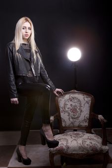 Sexy Girl In Leather Jacket With Her Leg On Vintage Chair Stock Photos