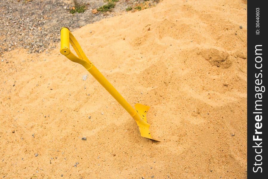 Yellow shovel in a sand. Yellow shovel in a sand.