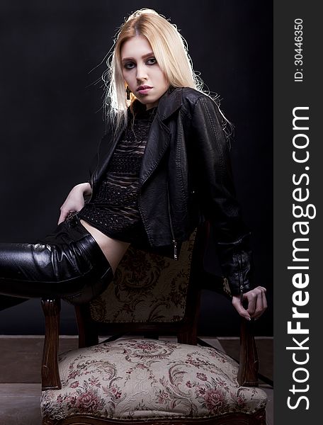 Sensual blonde model on a vintage chair