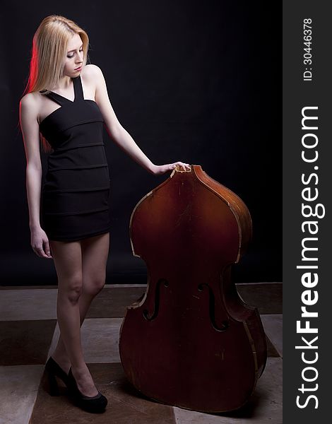 Beautiful model looking at a broken contrabass