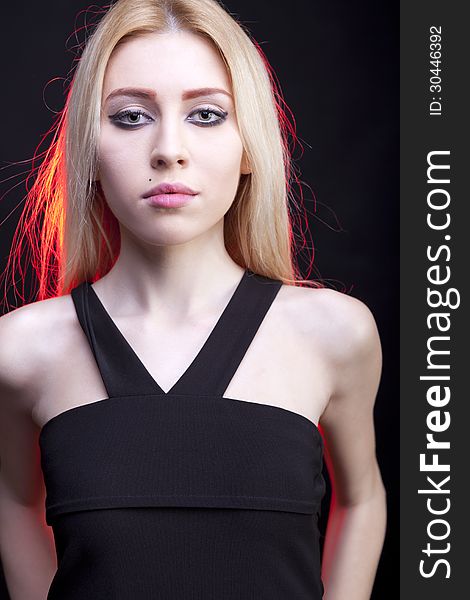 Close up portrait of beautiful girl with a red light behind studio shot