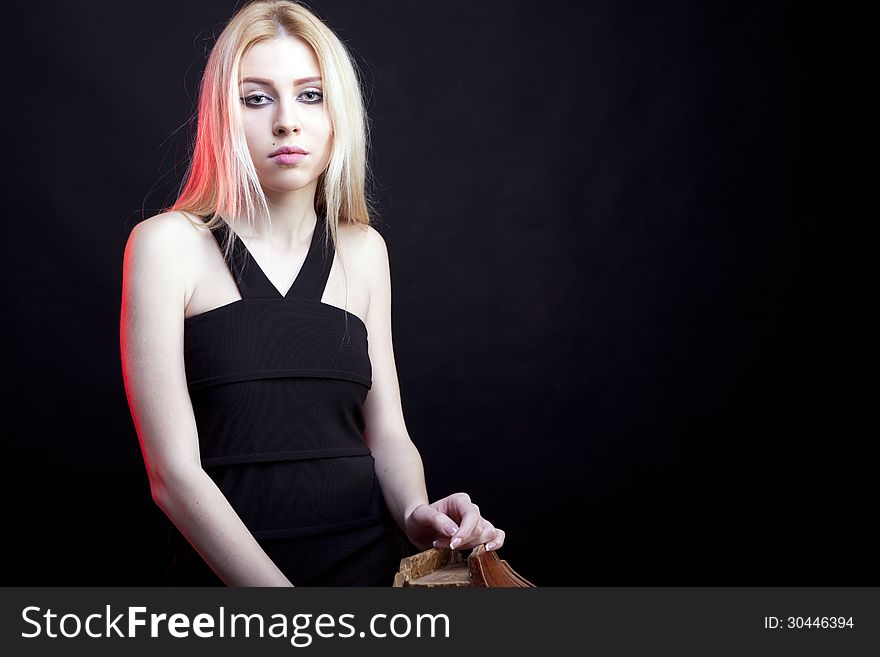 Attractive blonde model on a black background studio shot