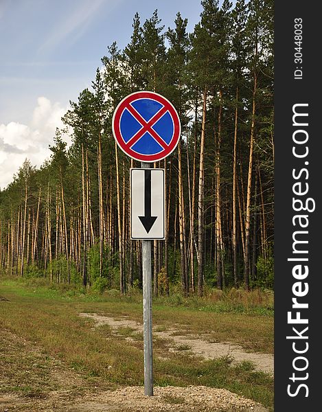 A road sign in a outskirts of the pine forest. A road sign in a outskirts of the pine forest.