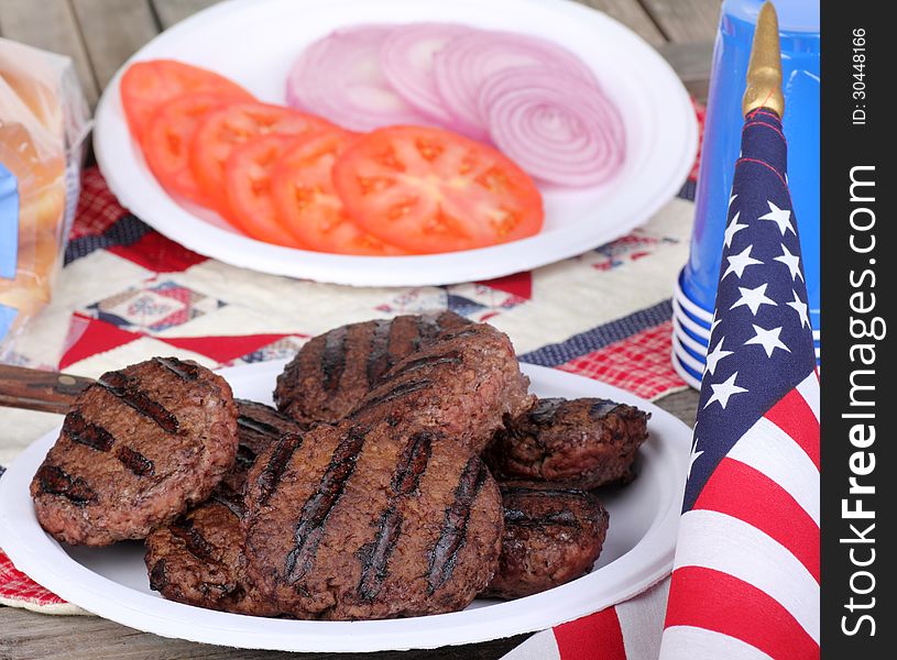 Grilled hamburgers on a plate with american flag. Grilled hamburgers on a plate with american flag
