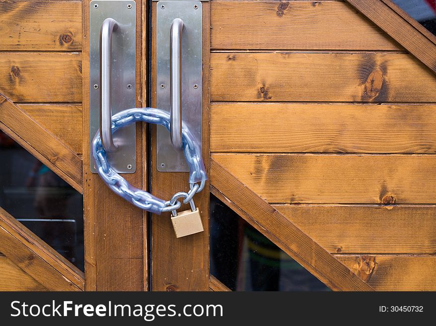 Iron lock and chain on wood door