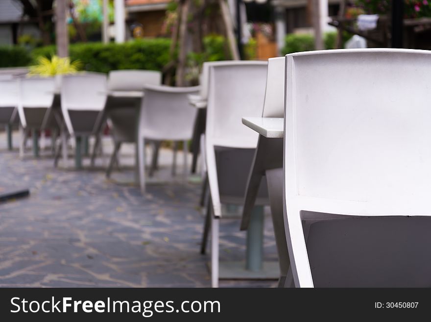 Outdoor restaurant with white desks and chairs