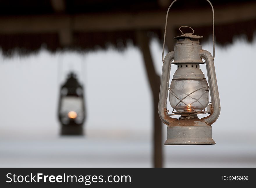 Metallic lanterns lighted, hang up to a roof. Metallic lanterns lighted, hang up to a roof.