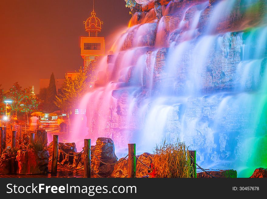 The image taken in china`s hebei province,qinhuangdao city,beidaihe district.At night colored lights illuminate the falls and create a charming turn away from. The image taken in china`s hebei province,qinhuangdao city,beidaihe district.At night colored lights illuminate the falls and create a charming turn away from.