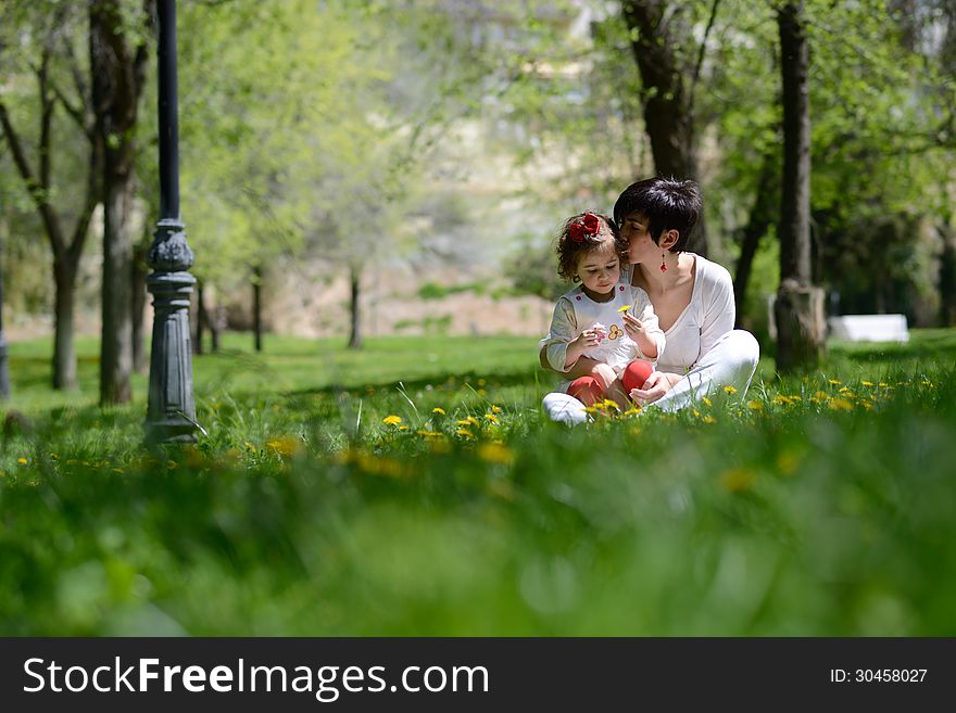 Portrait of mother and little girl playing in the park