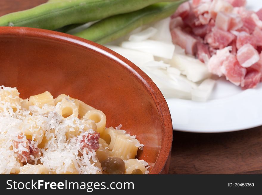 Typical dish of traditional Italian food, consisting of pasta, beans, bacon, onion and sheep cheese. Typical dish of traditional Italian food, consisting of pasta, beans, bacon, onion and sheep cheese