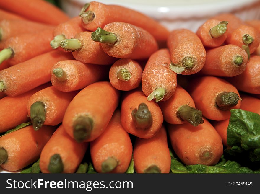 Close-up of piled fresh, orange carrots. Close-up of piled fresh, orange carrots.