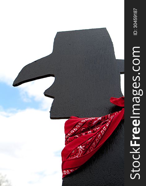Black silhouette of cowboy with red bandana