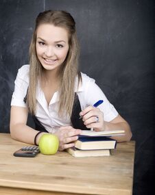 Cute Young Student Near Blackboard With Copy Book Calculator Pen, Copy Space Stock Photo Cute Young Student Near Blackboard With Copy Book Calculator Pen, Copy Space Stock Photo