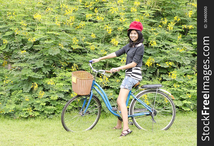 Smiling girl riding a bicycle in the park