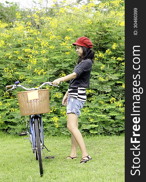 Young Woman With Retro Bicycle In A Park