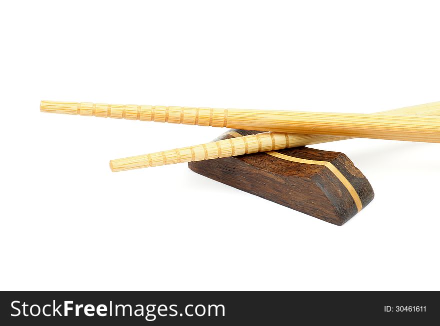 Pair of Beige Chopsticks and Brown Hasioki Cross Section on white background