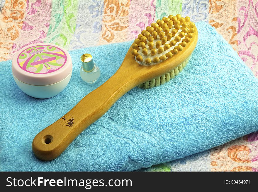 Wooden brush with the handle for massage of a body and a towel.