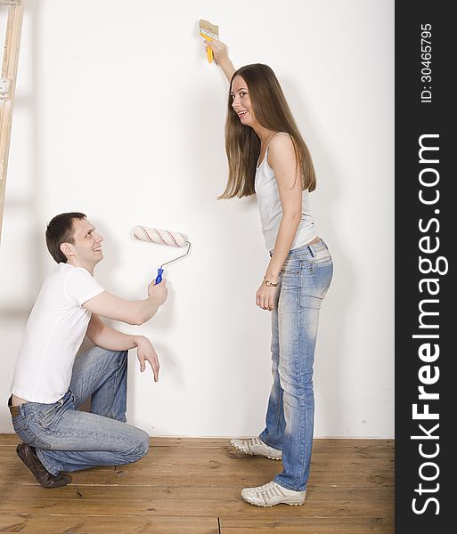 Portrait of happy family doing repair, parents with their son near ladder