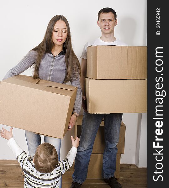 Smiling Family In New House Playing With Boxes