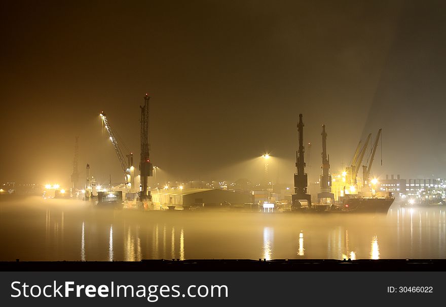 Ships in harbor of Hamburg at night and patch of fog. Ships in harbor of Hamburg at night and patch of fog.