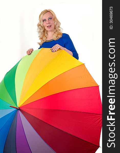 Attractive young blonde woman standing behind a large colored umbrella isolated on white. Attractive young blonde woman standing behind a large colored umbrella isolated on white