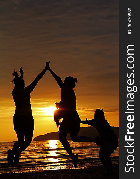 3 people jump on the beach during sunset. Happy and Freedom. 3 people jump on the beach during sunset. Happy and Freedom