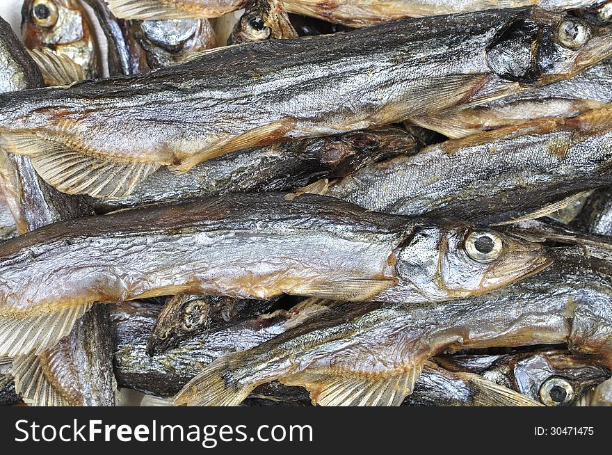 Closeup of pile of dried salted capelin Mallotus villosus fish from Russia. Closeup of pile of dried salted capelin Mallotus villosus fish from Russia