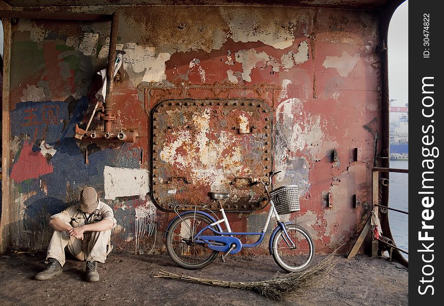 Worker resting in shipyards dry dock. Worker resting in shipyards dry dock