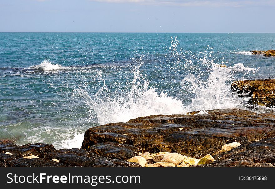 Waves crashing on the rocks of a beach