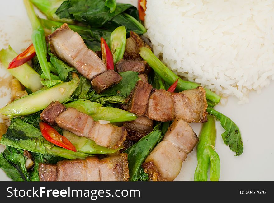 Stir-fried kale with crispy pork and rice. Stir-fried kale with crispy pork and rice