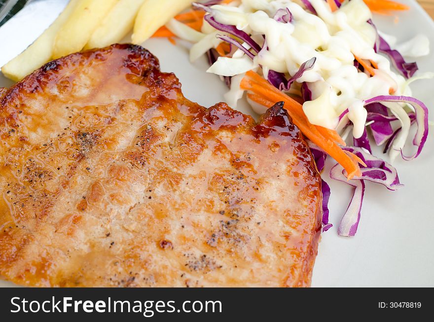 Pork steak with salad and French fries