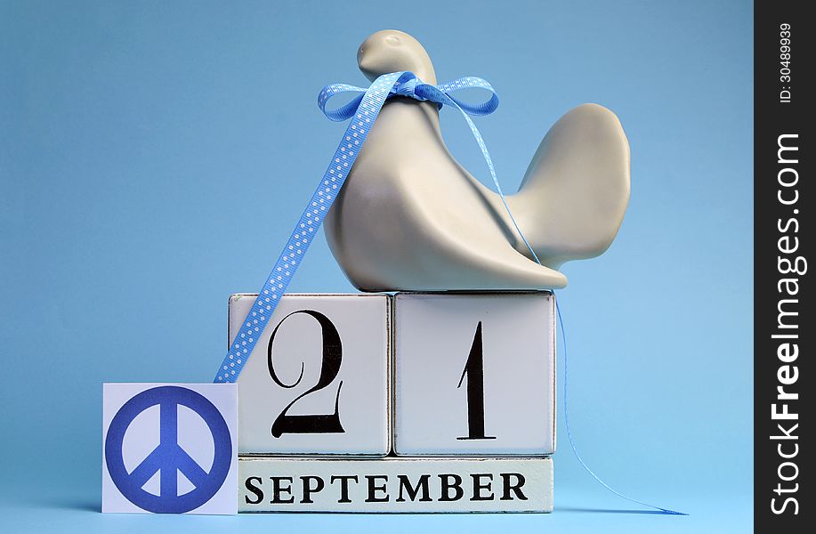 Dove and Peace Sign decorations for International Day of peace, World Peace Day, with white block calendar date on pale blue background. Dove and Peace Sign decorations for International Day of peace, World Peace Day, with white block calendar date on pale blue background.