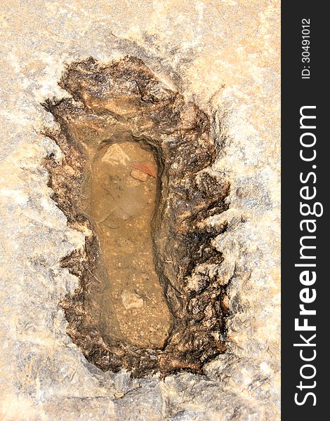 Single foot print in the old stone of Acropolis, Lindos, Rhodes