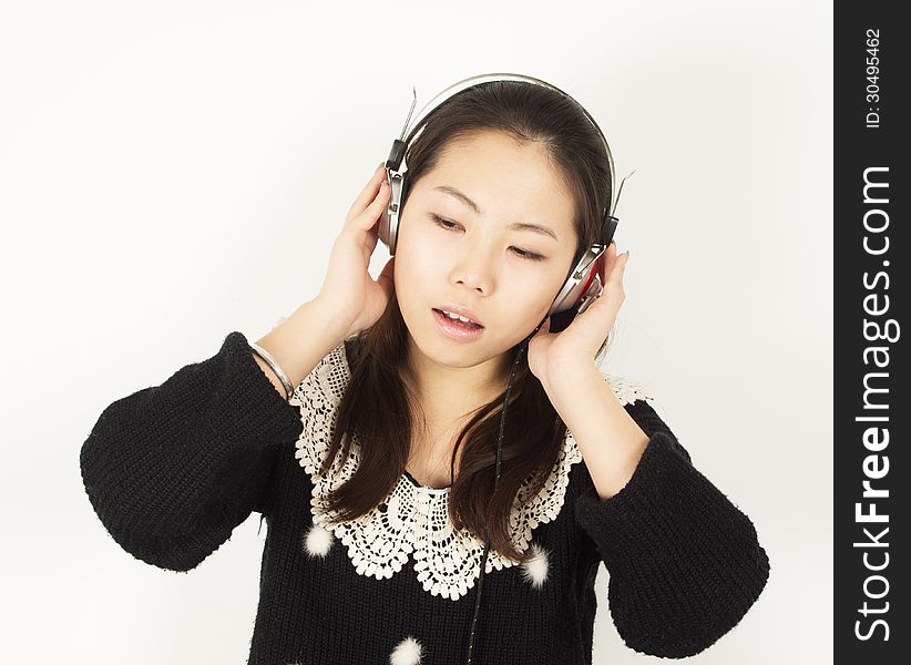 Young woman listening to music with headphones.