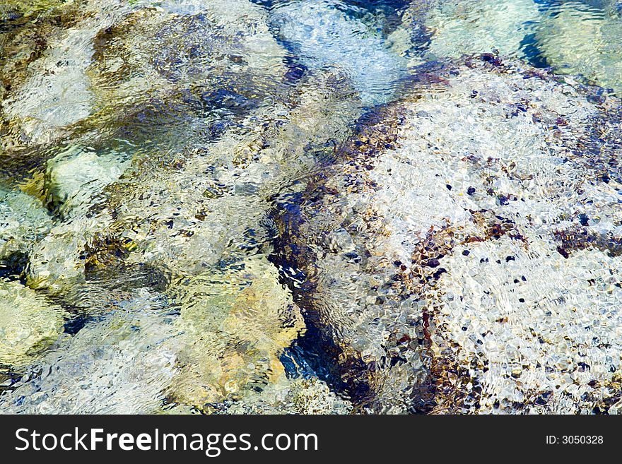 Background picture of reefs washed by the sea wave