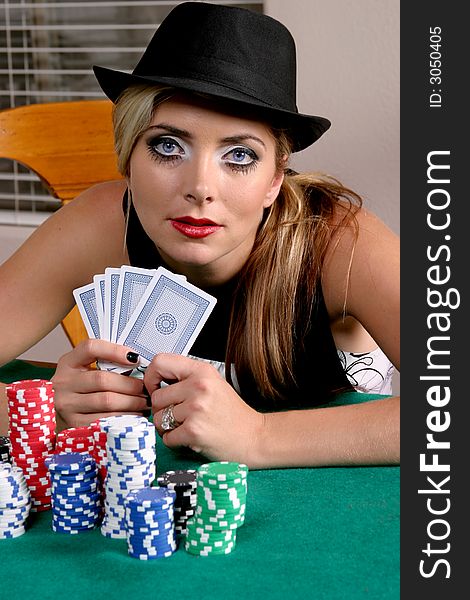 Colorful portrait of woman in a black hat with cards and gambling chips. Colorful portrait of woman in a black hat with cards and gambling chips.