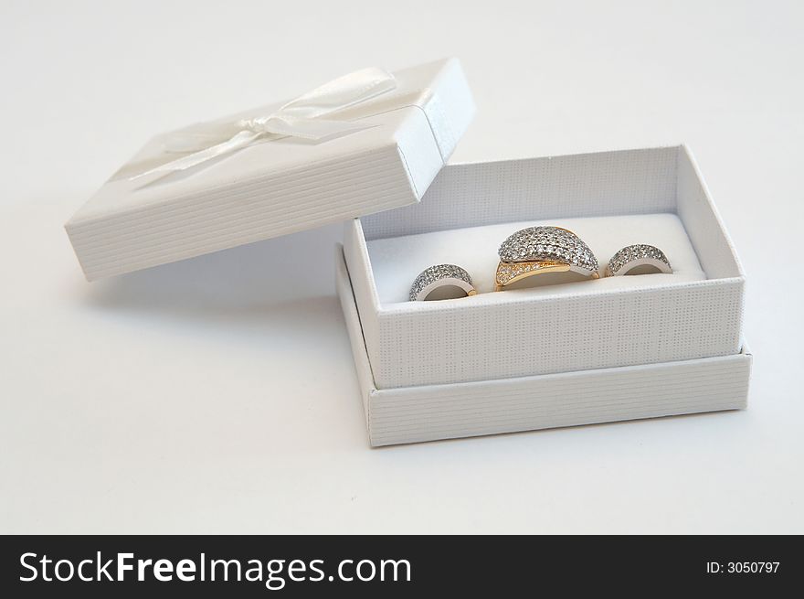 Golden ring and earrings in a white gift box