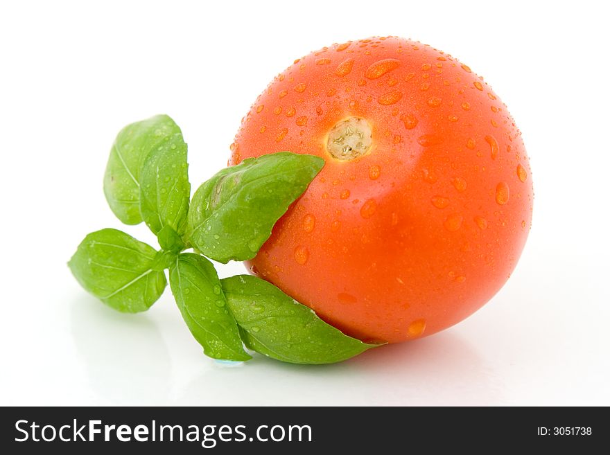 Tomato with basil isolated over white background. Tomato with basil isolated over white background