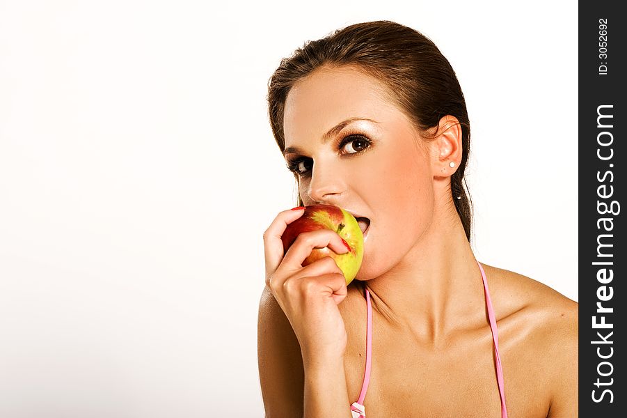 A beautiful woman eating a red apple. A beautiful woman eating a red apple
