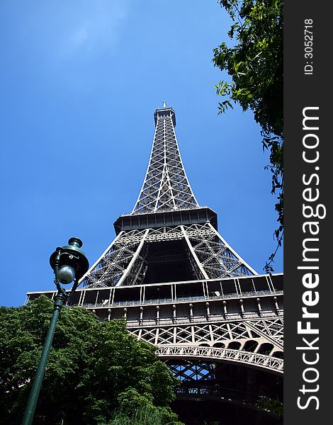 Low vantage image of the Eiffel Tower on a clear summer day in Paris, France