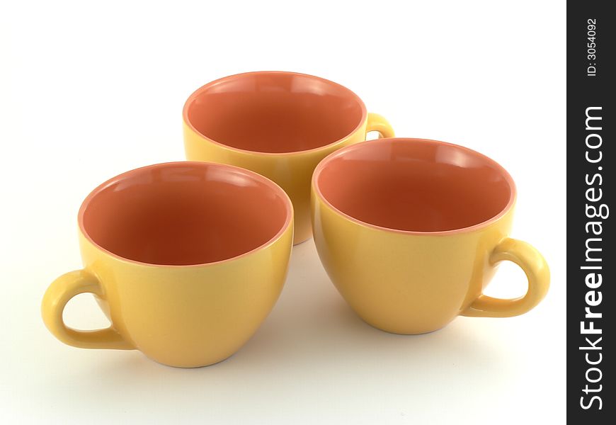 Three isolated yellow empty cups. Three isolated yellow empty cups