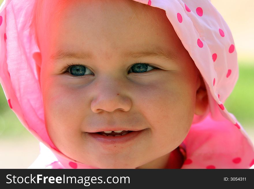 Lovely little baby in the spotted pink scarf. Lovely little baby in the spotted pink scarf