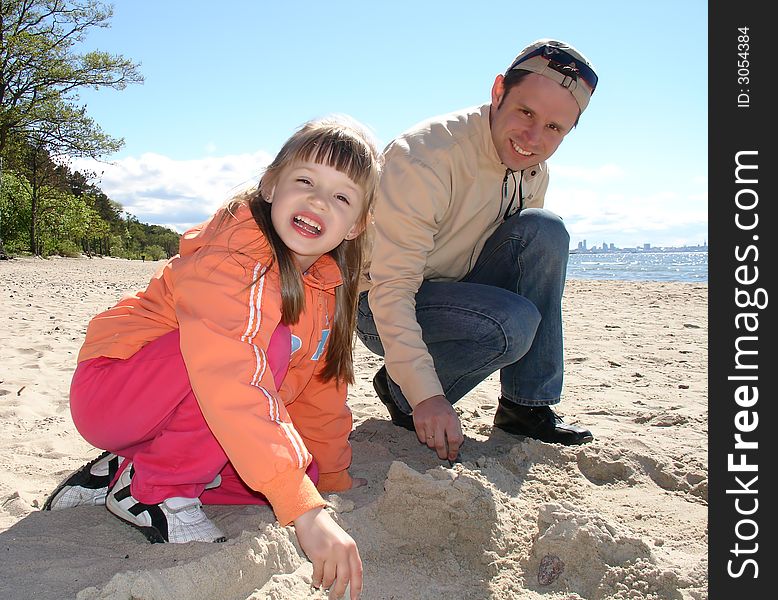 Father and daughter at the beach on autumn. Father and daughter at the beach on autumn