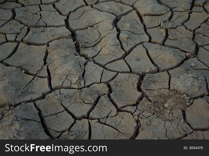 Cracked dry  clay soil background. Cracked dry  clay soil background